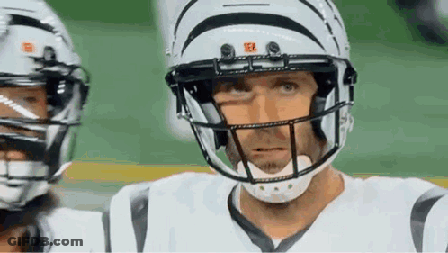 Football Player In Helmet And White Jersey Looking At Camera GIF