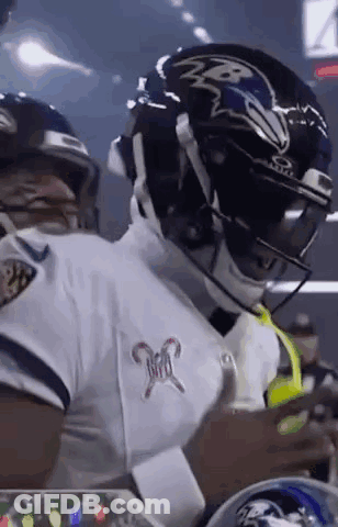 Football Player In Helmet And White Jersey Standing On Field GIF