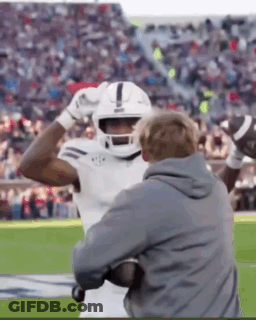 Football Player In Helmet Held By Coach GIF