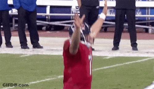 Football Player In Helmet Holding American Flag GIF