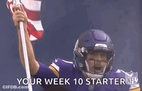 Football Player In Helmet Holding American Flag GIF