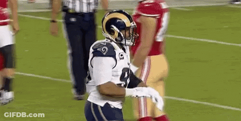 Football Player In Helmet Holding Football GIF