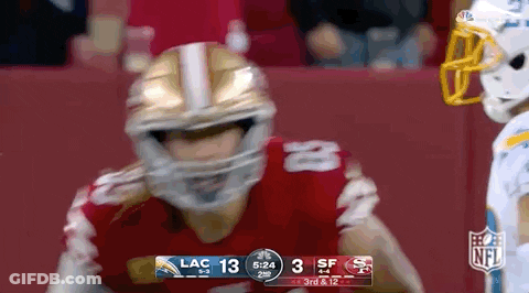 Football Player In Helmet In Front Of Scoreboard GIF