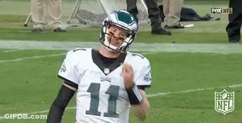 Football Player In Helmet Standing On Field GIF