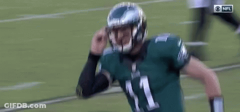 Football Player In Helmet Standing On Field GIF