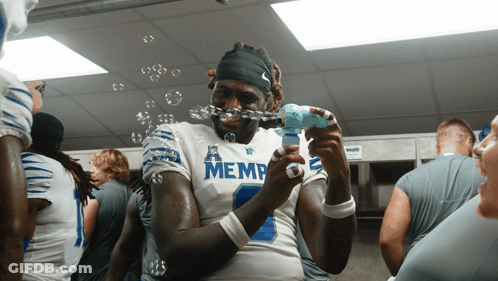 Football Player In Memphis Jersey Blowing Bubbles GIF