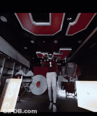 Football Player In Number 1 Jersey In Front Of Large U GIF