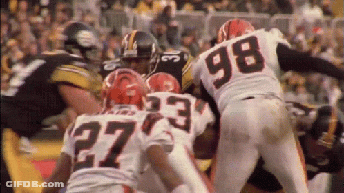 Football Player In Number 27 Jersey Surrounded By Players GIF