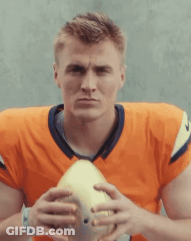 Football Player In Orange Jersey Holding Football GIF
