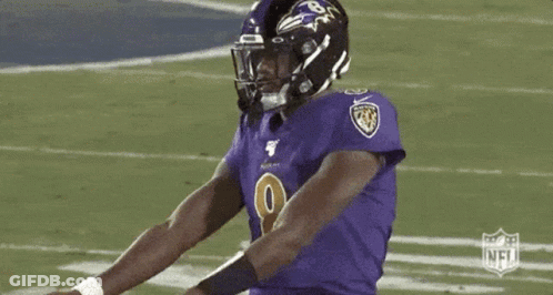 Football Player In Purple Jersey And Black Helmet GIF