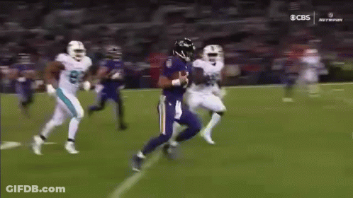 Football Player In Purple Jersey Being Tackled GIF