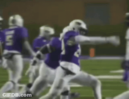 Football Player In Purple Jersey Number 24 Being Tackled GIF
