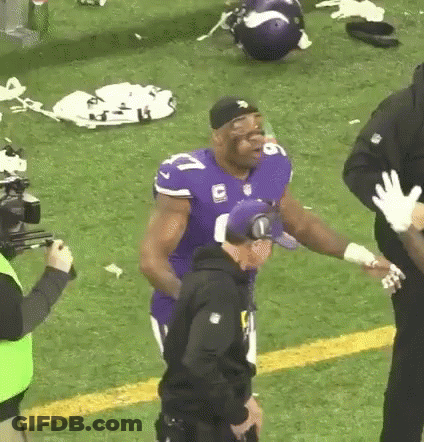 Football Player In Purple Jersey With Police Officer GIF