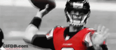 Football Player In Red And Black Uniform Throwing Football GIF