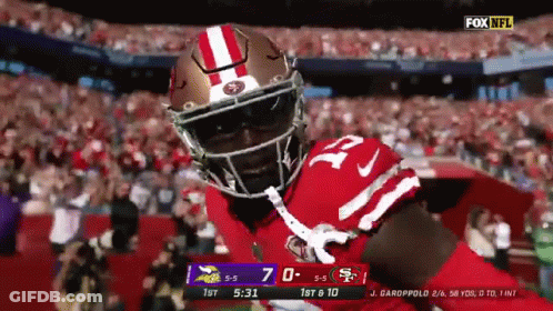 Football Player In Red And White Helmet In Front Of Crowd GIF