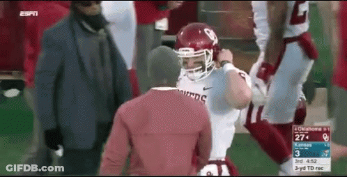 Football Player In Red Helmet Next To Man In Red Shirt GIF