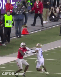 Football Player In Red Jersey Catching Pass From Player In White GIF