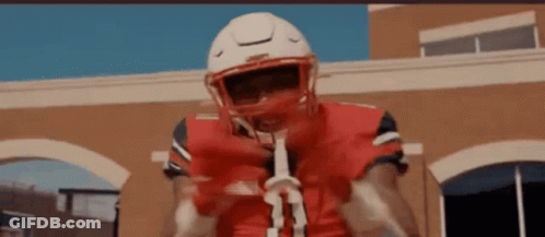 Football Player In Red Jersey Holding Stick GIF