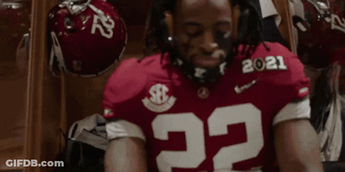 Football Player In Red Jersey Number 22 Sitting With Eyes Closed GIF