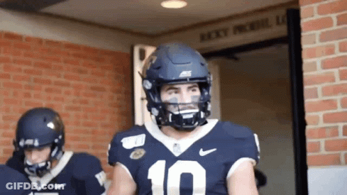 Football Player In Red Jersey Number 4 Surrounded GIF