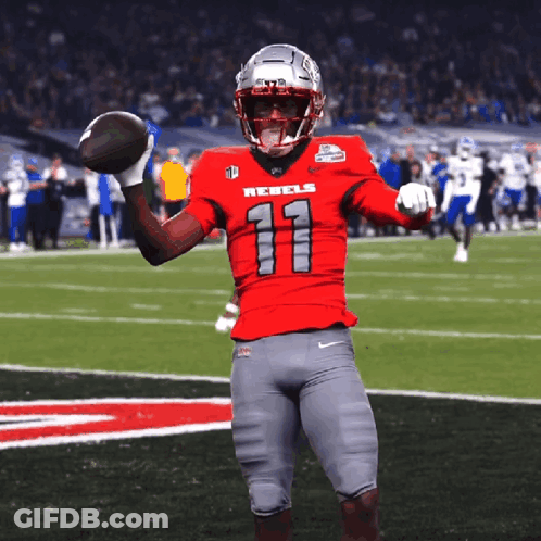 Football Player In Red Rebels Jersey Holding Football GIF