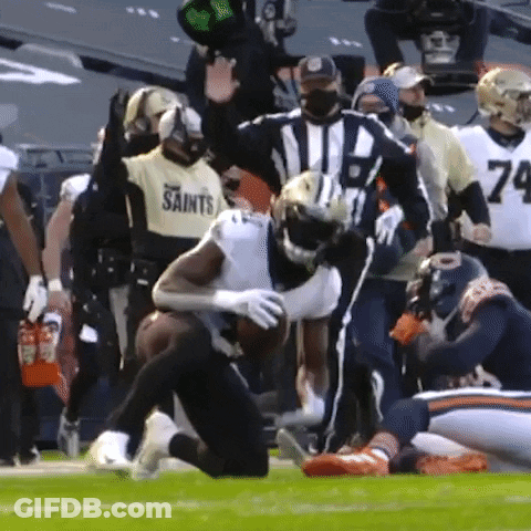 Football Player In Saints Jersey Being Tackled GIF