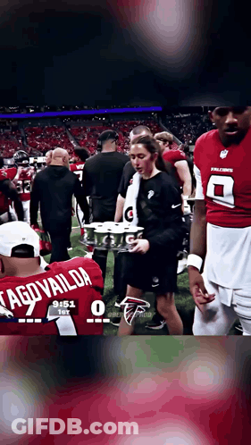 Football Player In Tagovailoa Jersey Holding Drinks GIF
