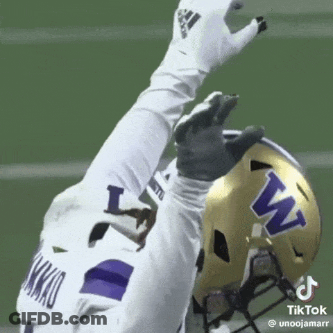 Football Player In White Jersey And Purple Helmet Reaching Up GIF