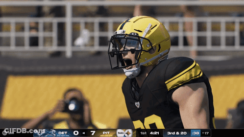 Football Player In Yellow Helmet In Front Of Scoreboard GIF