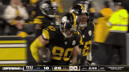 Football Player In Yellow Helmet In Front Of Scoreboard GIF