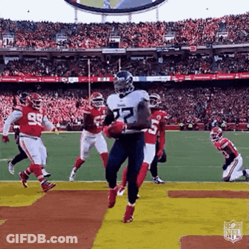 Football Player Jumping Holding Ball GIF