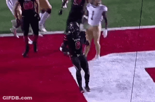 Football Player Jumping Holding Football GIF