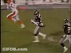 Football Player Jumping To Catch Ball With Defender GIF