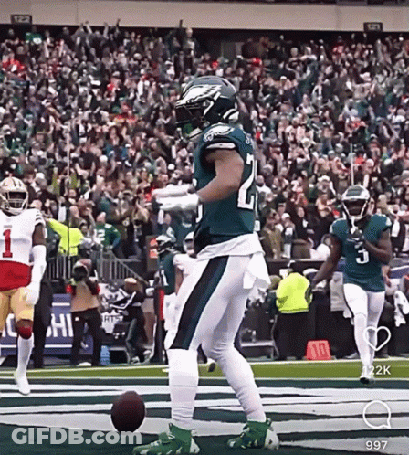 Football Player Kicking Ball In Green And White Uniform GIF