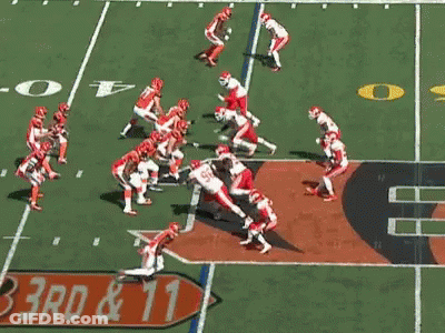 Football Player Kicking Ball With Referee Watching GIF