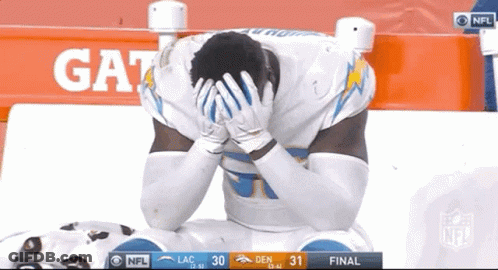 Football Player Kneeling Hands On Head In Front Of Gatorade Sign GIF