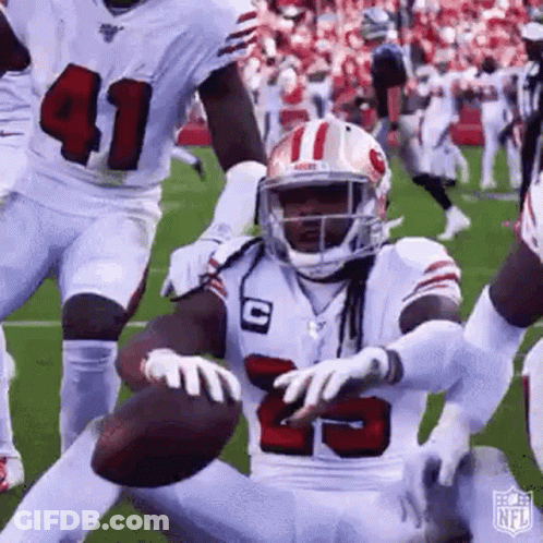 Football Player Kneeling Holding Football GIF