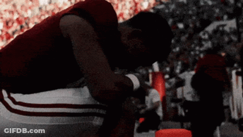 Football Player Kneeling In Crowded Stadium GIF