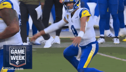 Football Player Kneeling In Front Of Game Of The Week Sign GIF