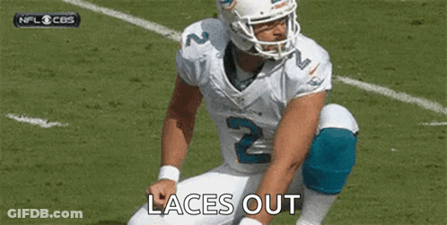 Football Player Kneeling Tying Shoes GIF