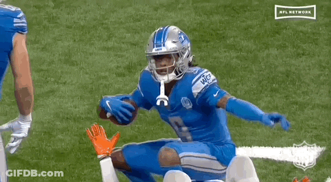 Football Player Kneeling While Another Holds Football GIF