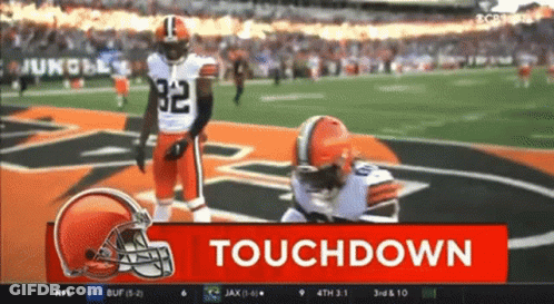 Football Player Kneeling With Touchdown Sign GIF