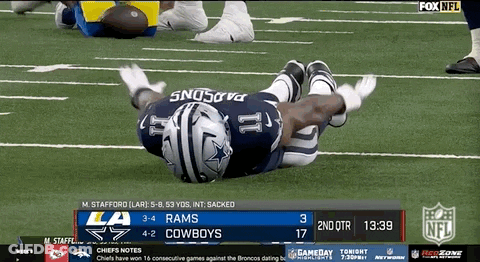 Football Player Laying On Field During Game GIF
