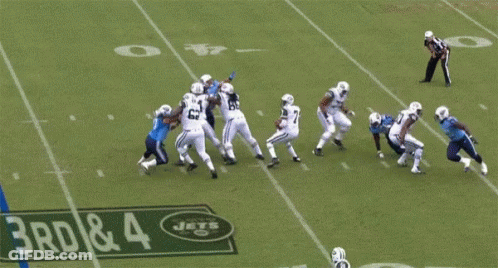 Football Player Leaps Over Sign Saying 3Rd & 4 GIF