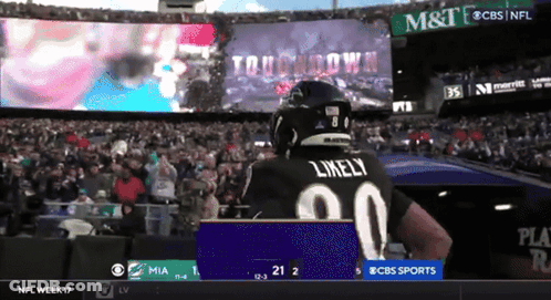 Football Player Likely Standing Before Large Screen GIF