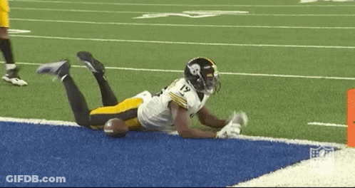Football Player Lying On Field With Ball GIF