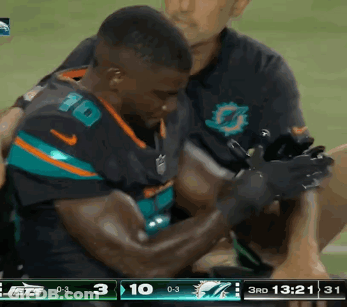 Football Player Number 10 Helped Off Field GIF