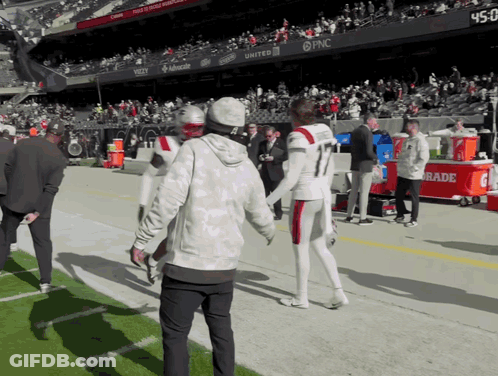 Football Player Number 11 Talking To Another Player GIF