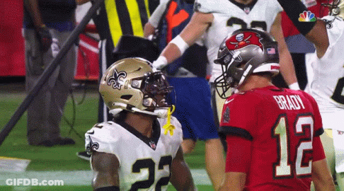 Football Player Number 12 Beside Another Player GIF