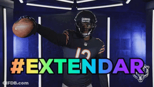 Football Player Number 12 Holding Football In Front Of Extendar Sign GIF